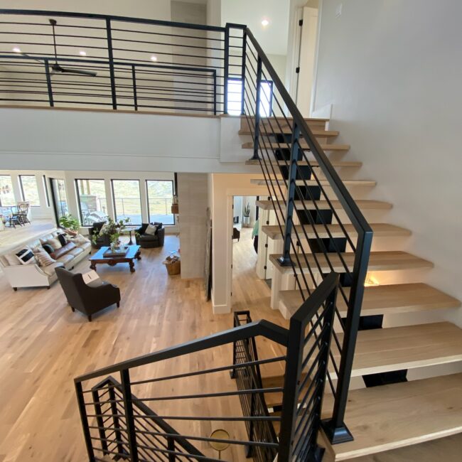 Wooden stairwell with black railing